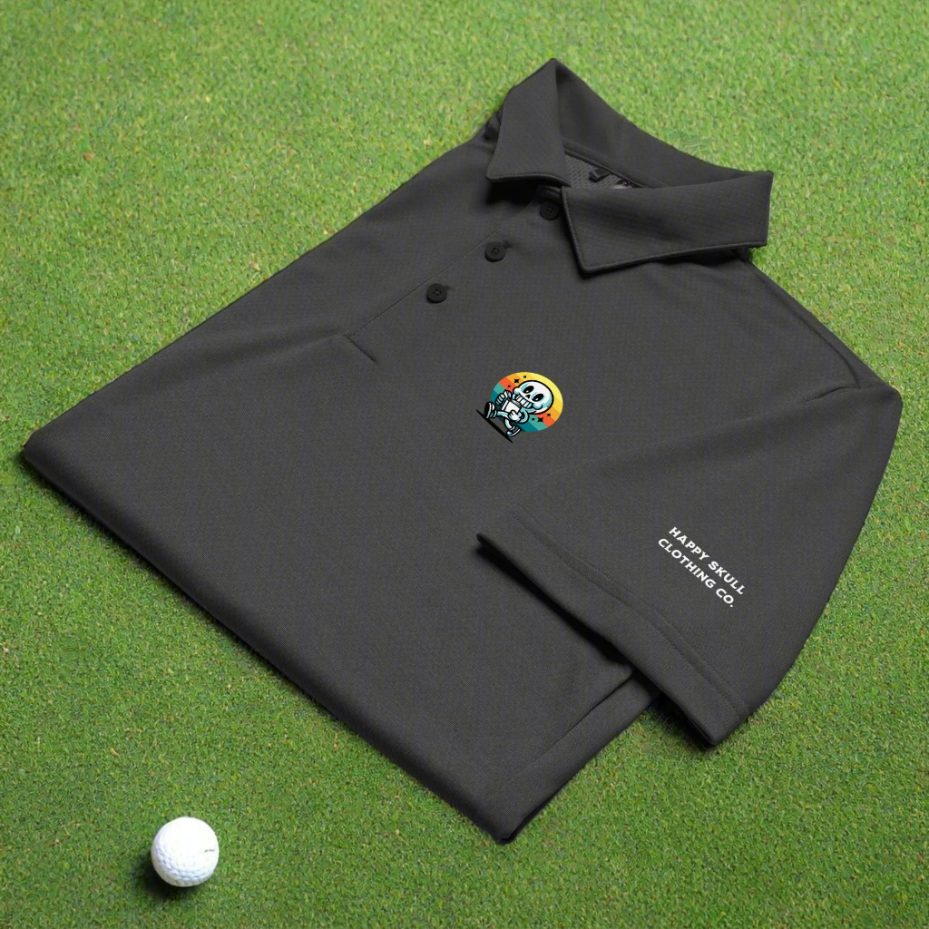 Black polo shirt with a colorful skull design and 'Nasty Soul Clothing Co' text on a green surface with a golf ball.