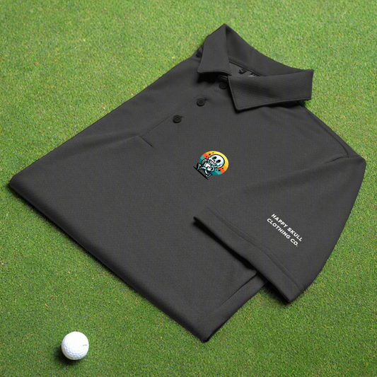 Black polo shirt with a colorful skull design and 'Nasty Soul Clothing Co' text on a green surface with a golf ball.