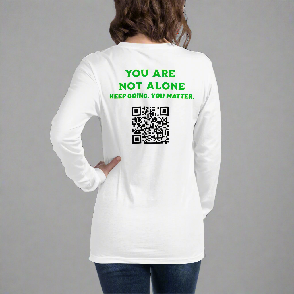 Someone wears the You Are Not Alone Mental Health Awareness Unisex Long Sleeve Tee, a white shirt with green text—YOU ARE NOT ALONE. KEEP GOING. YOU MATTER—and a large QR code below, promoting the importance of mental health.