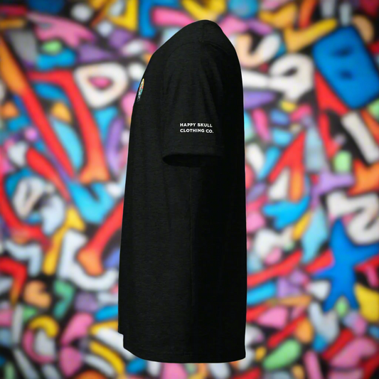 The Happy Skull Logo Tri-Blend Tee, shown in black from the side against a vibrant graffiti backdrop, features Happy Skull Clothing Co. printed in white on the sleeve to promote mental health awareness.