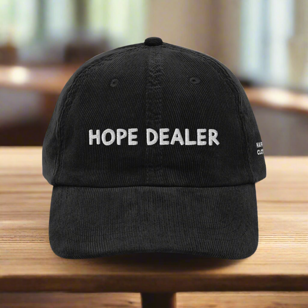 Black cap with 'HOPE DEALER' text on a white background